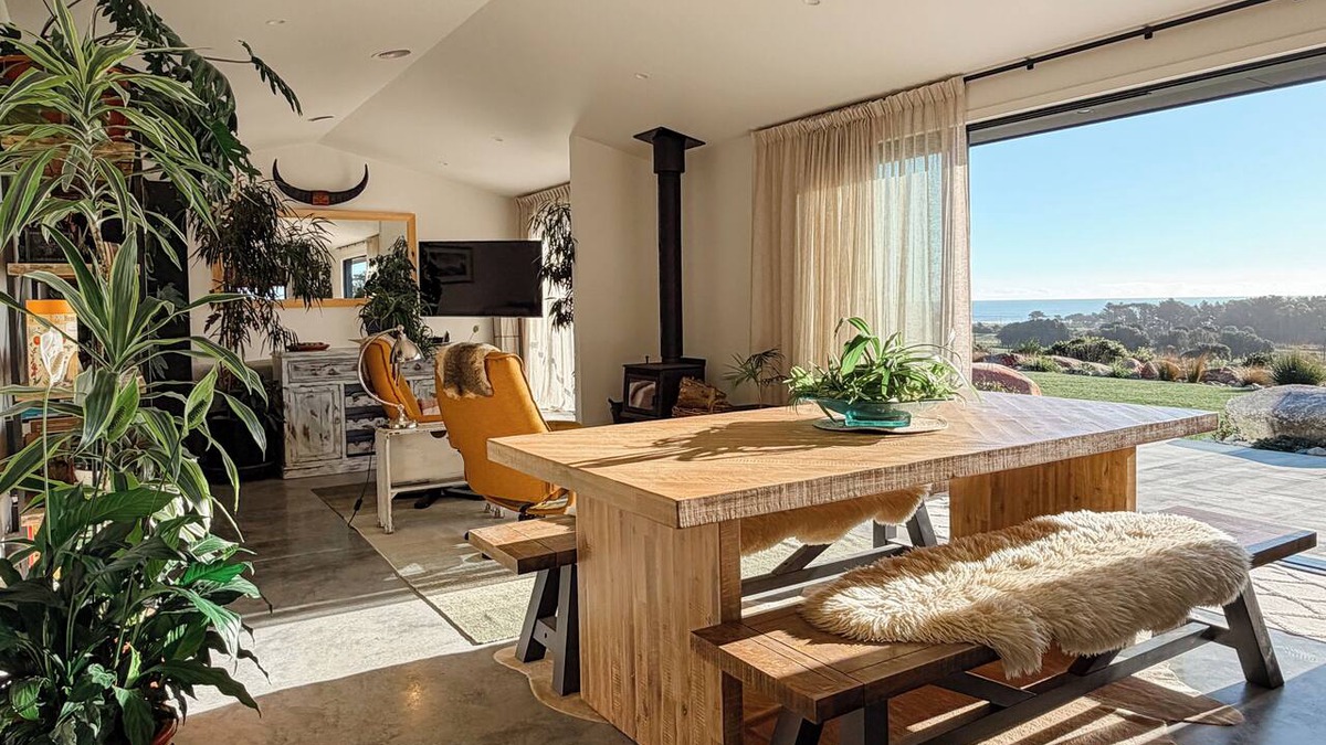 Hokitika House | Brand new and beautifully designed, this striking ridge-top retreat blends modern industrial style with lush botanicals and breathtaking West Coast views. It’s the perfect place to slow down, gather around the fire and watch unforgettable sunsets.