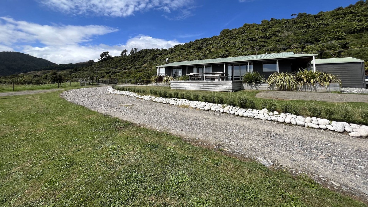 Mokihinui House | Large home with stunning sunset views.