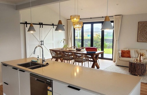 Papamoa Beach House | Coastal spacious 4-bedroom house close to beach with spa.