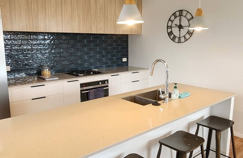 Papamoa Beach House | Coastal spacious 4-bedroom house close to beach with spa.