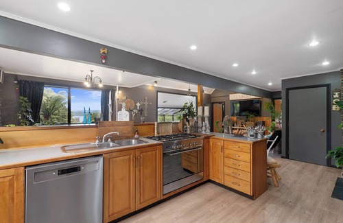 Okere Falls House | ŌKERE Ridge - Stone, native timber and tree ferns overlooking Lake Rotoiti