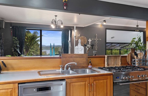 Okere Falls House | ŌKERE Ridge - Stone, native timber and tree ferns overlooking Lake Rotoiti