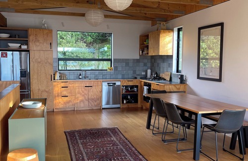 Matapouri House | Peaceful 4-Bedroom Beach House across road from estuary & fantastic beach views