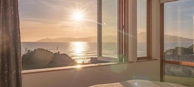 Absolute beachfront home with stunning views in Raumati. Sleeps up to 18 people.