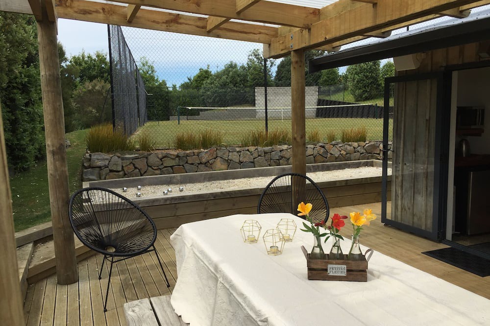 Raglan House | Okete Landing - Lifestyle retreat on Raglan harbour with grass tennis court.