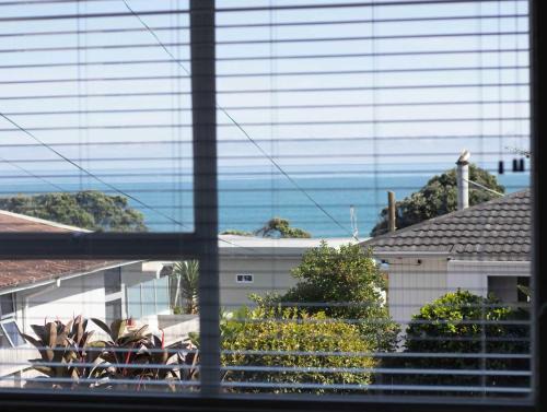 Rewa House | Blue Water Cottage - with beachfront coastal views
