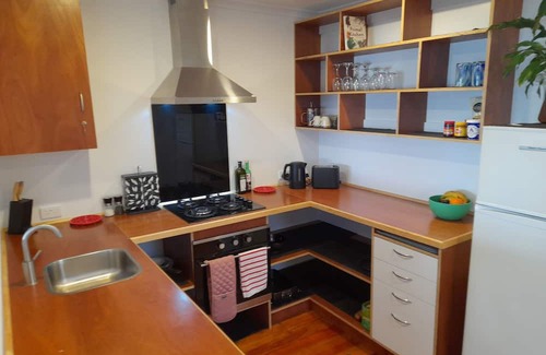 Plimmerton Cottage | Absolute Beach Front, 25 mins from Wellington Sunset spa deck. Cosy Fire lounge.