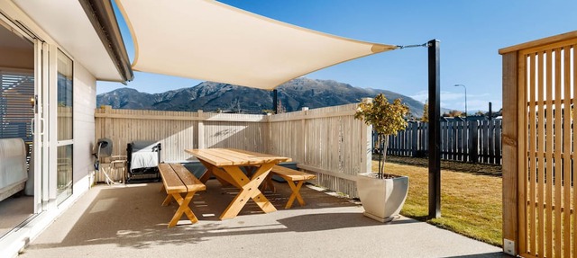 Home nestled in Hawea - A four-bedroom Hawea home with mountain views. Enjoy a modern kitchen, spacious living areas, two bathrooms, and a cosy fireplace