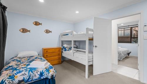 Waterfront location with estuary outlook and ocean beach access - sleeps 19